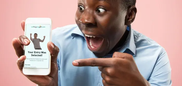 Man pointing at his smartphone with an excited expression, showing an app