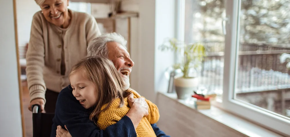 Elderly man hugging his grandchild, showing family connection and care