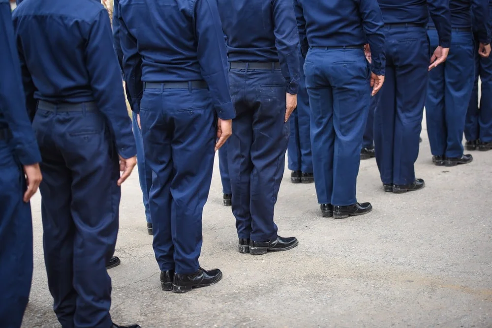 Sea Cadets in uniform standing in formation in a disciplined military-style pose